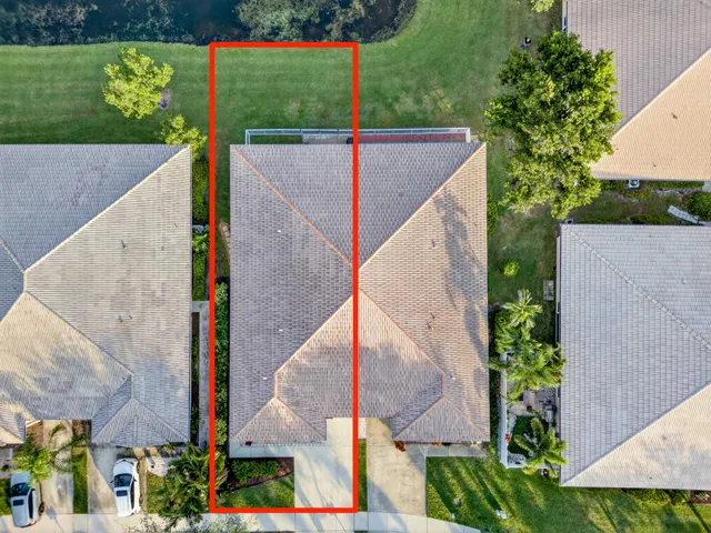 an aerial view of residential houses with outdoor space and swimming pool