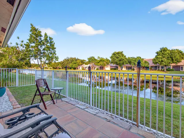 a view of a chair and table in the garden