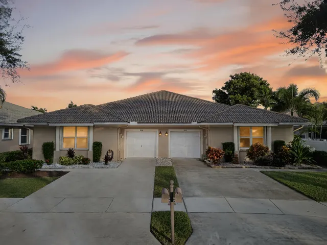 a view of a white house with a patio