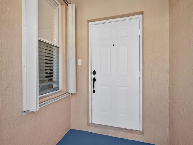 a view of a hallway with wooden floor and closet