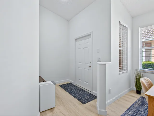 a view of room with couch and windows