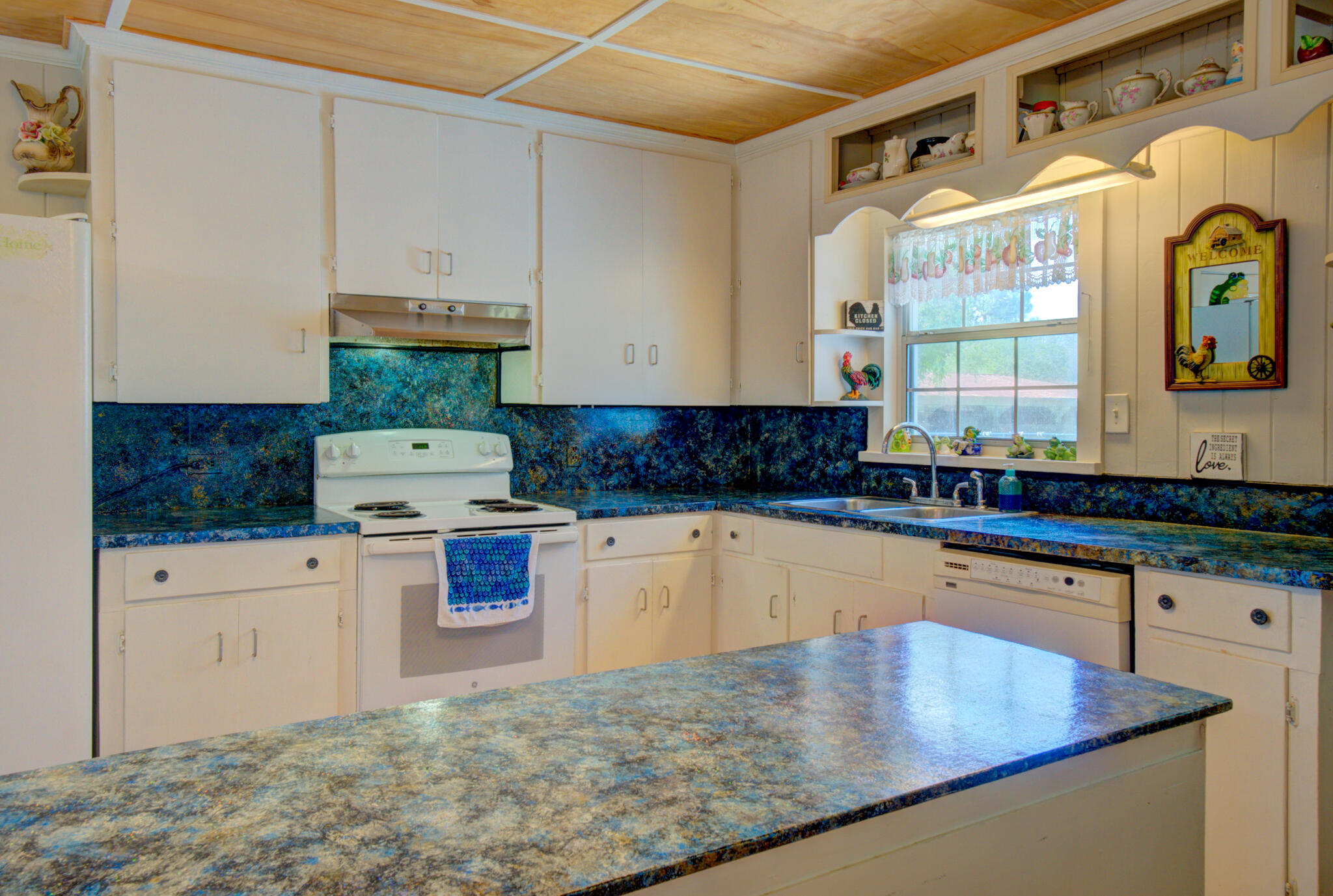 4135 Cliff Road Graceville, FL 32440 - Photo 11 of 40 a kitchen with stainless steel appliances granite countertop a sink a stove and white cabinets