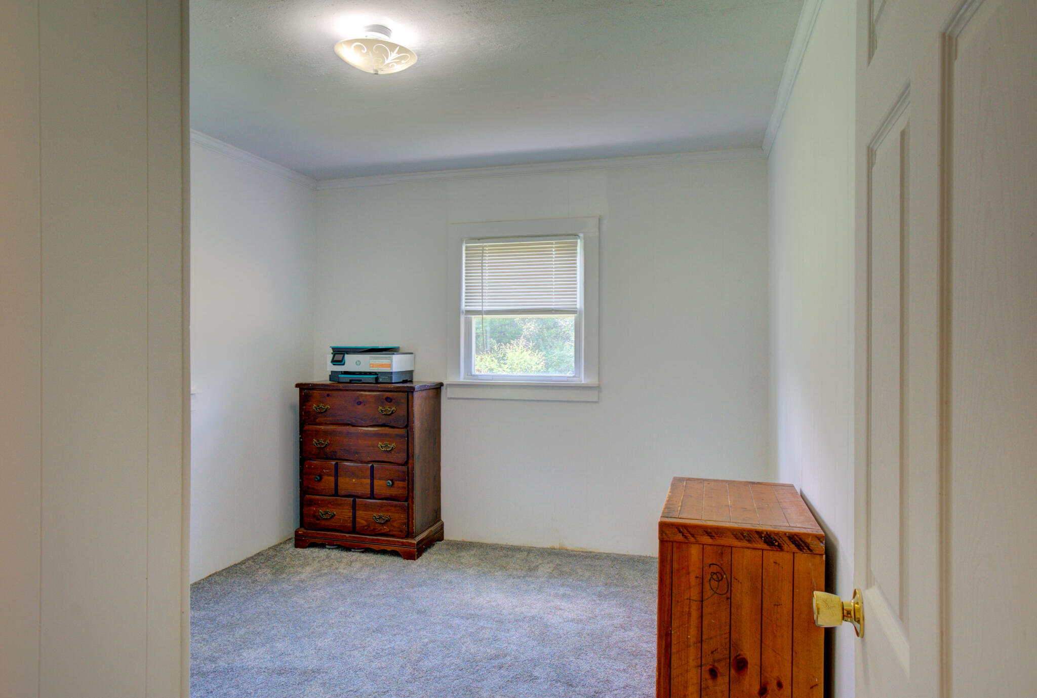 4135 Cliff Road Graceville, FL 32440 - Photo 17 of 40 an empty room with a window and dresser
