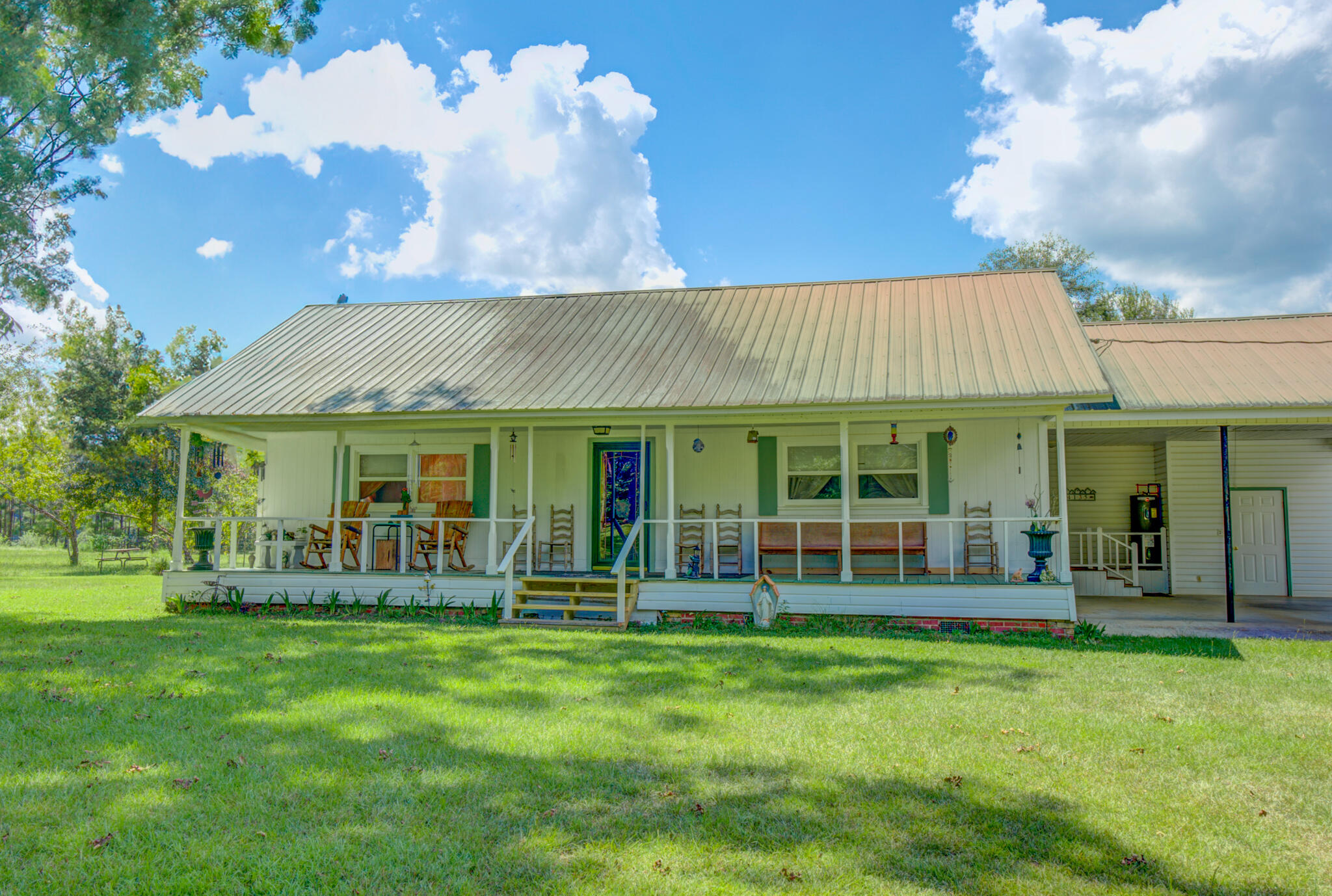 4135 Cliff Road Graceville, FL 32440 - Photo 2 of 40 a view of a house with a yard porch and sitting area