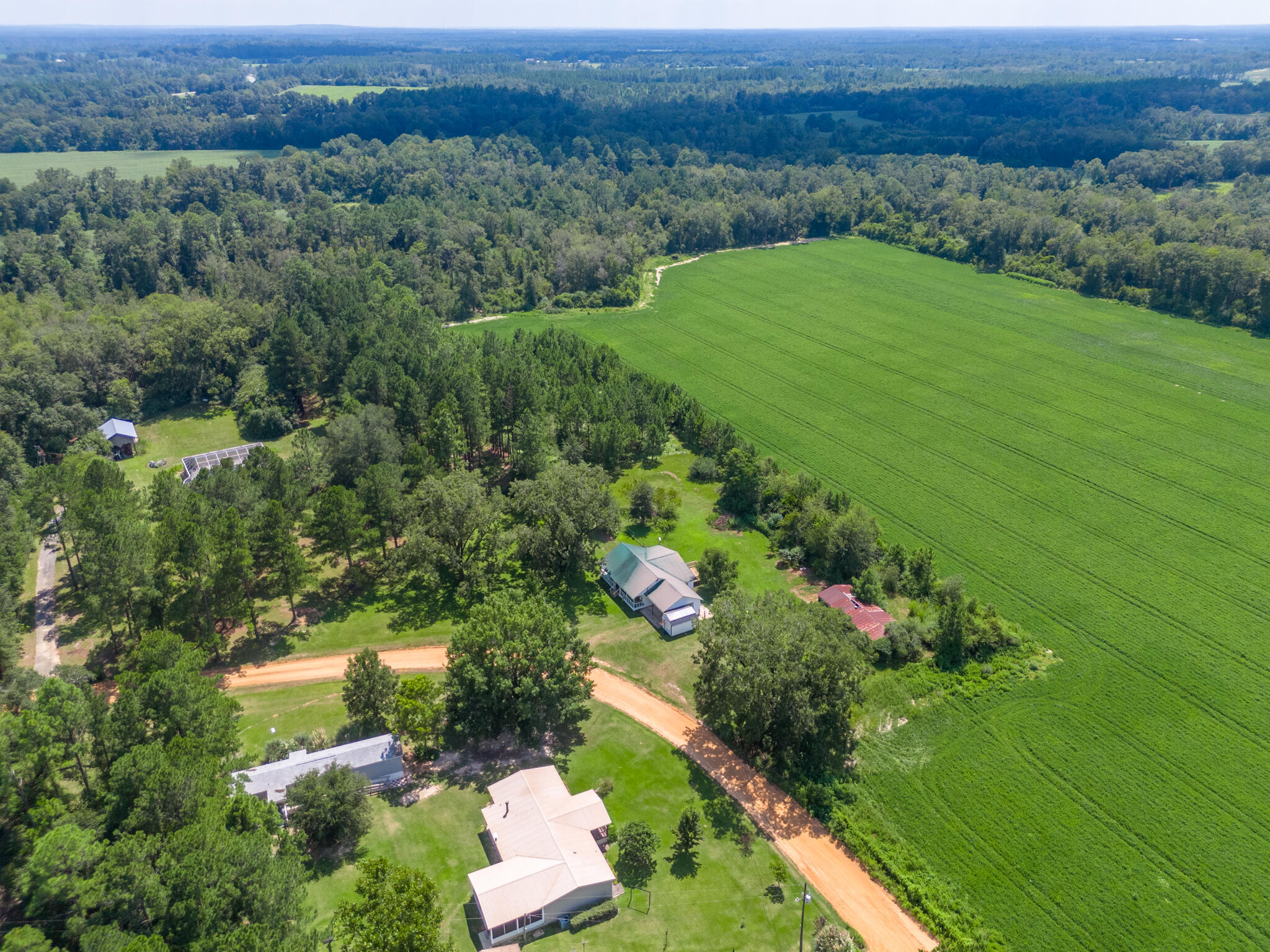 4135 Cliff Road Graceville, FL 32440 - Photo 40 of 40 an aerial view of green landscape with trees houses and mountain view