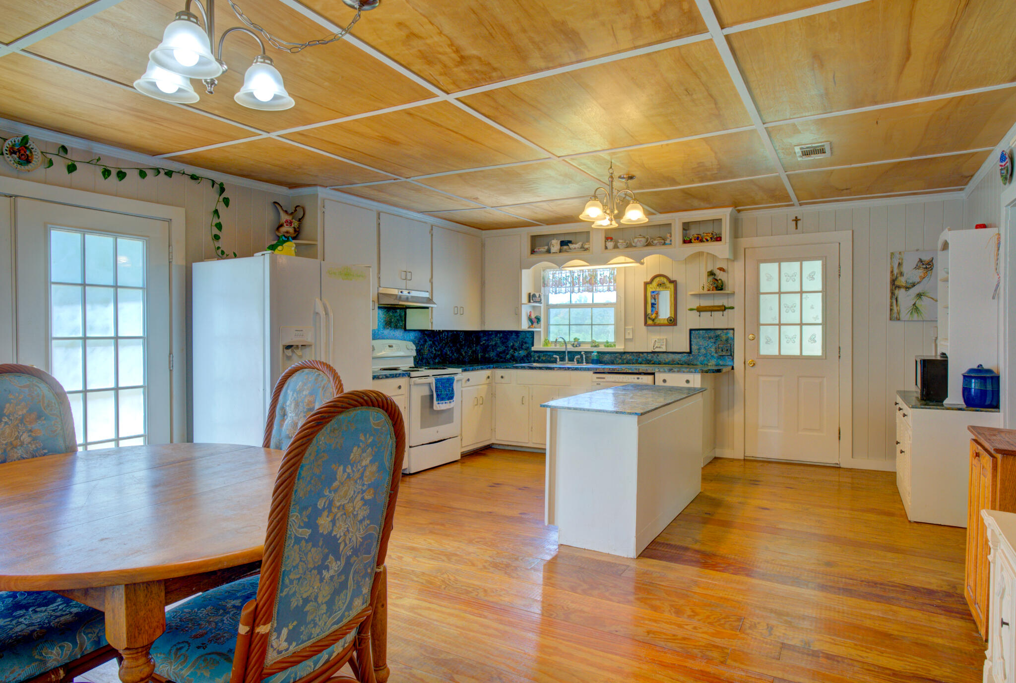 4135 Cliff Road Graceville, FL 32440 - Photo 8 of 40 a kitchen with granite countertop stainless steel appliances a dining table chairs and granite counter tops