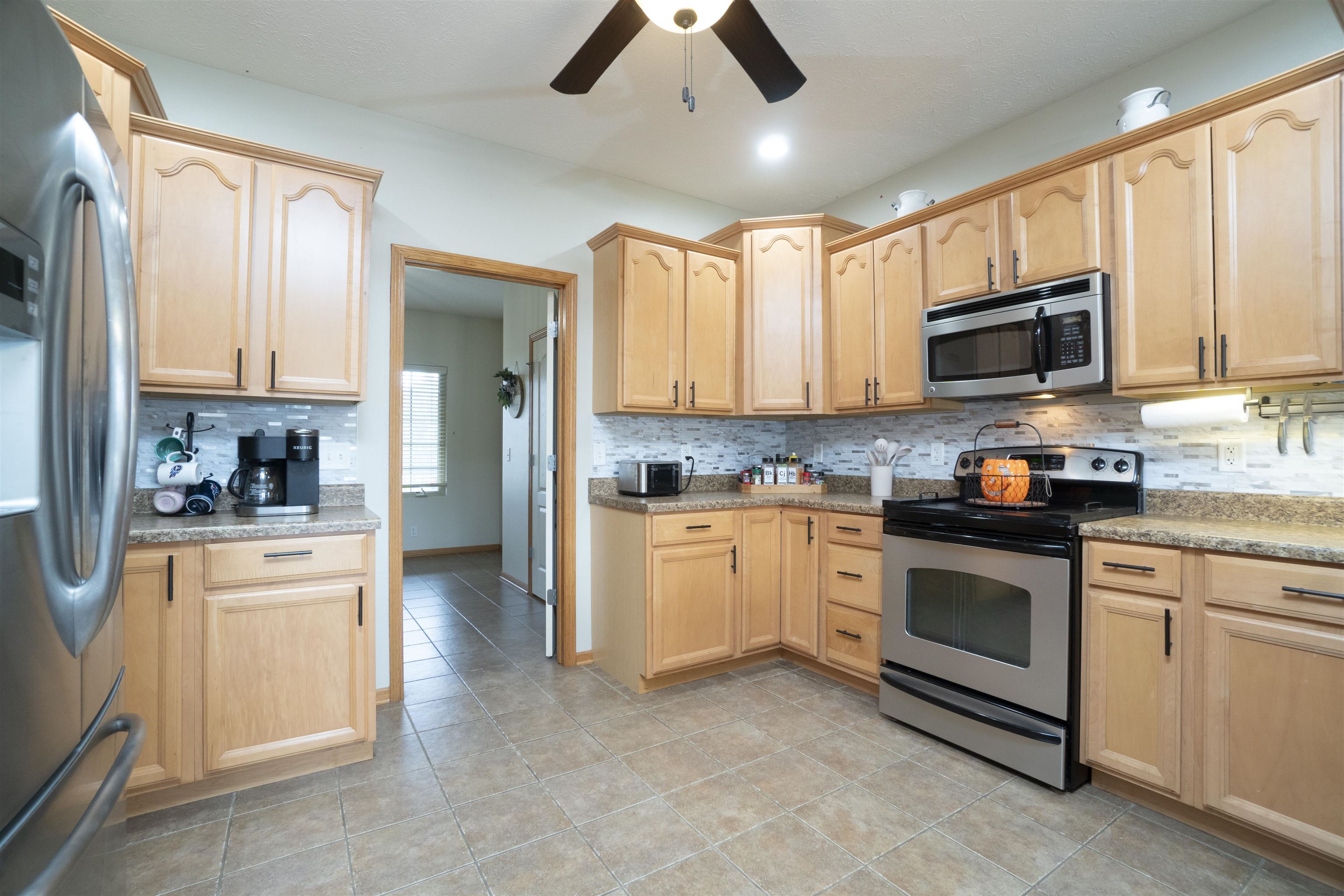 3271 North Silver Ridge Drive Oregon, IL 61061 - Photo 12 of 45 a kitchen with stainless steel appliances granite countertop a stove sink microwave and cabinets