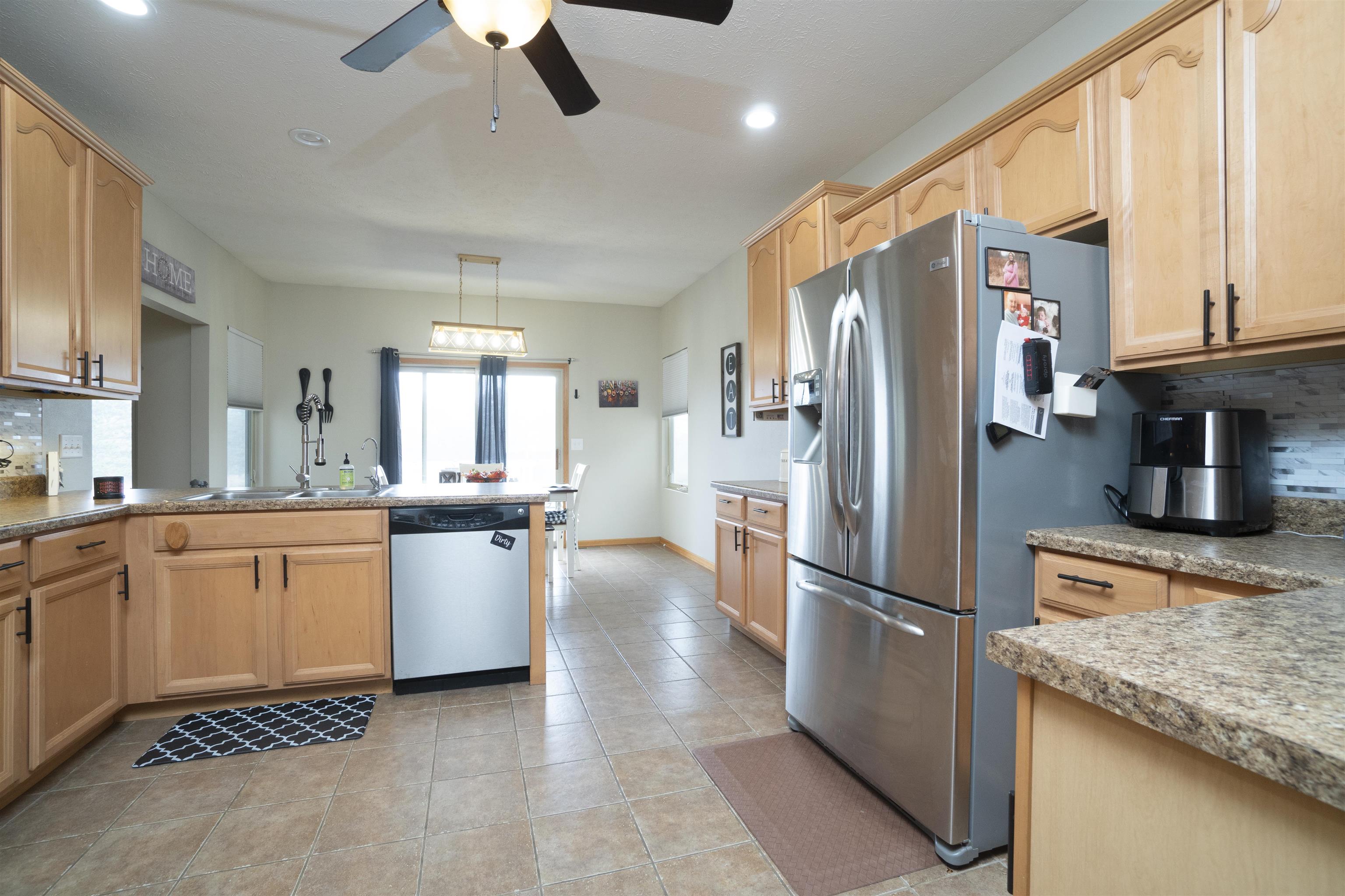 3271 North Silver Ridge Drive Oregon, IL 61061 - Photo 14 of 45 a kitchen with stainless steel appliances granite countertop a refrigerator a stove and a sink