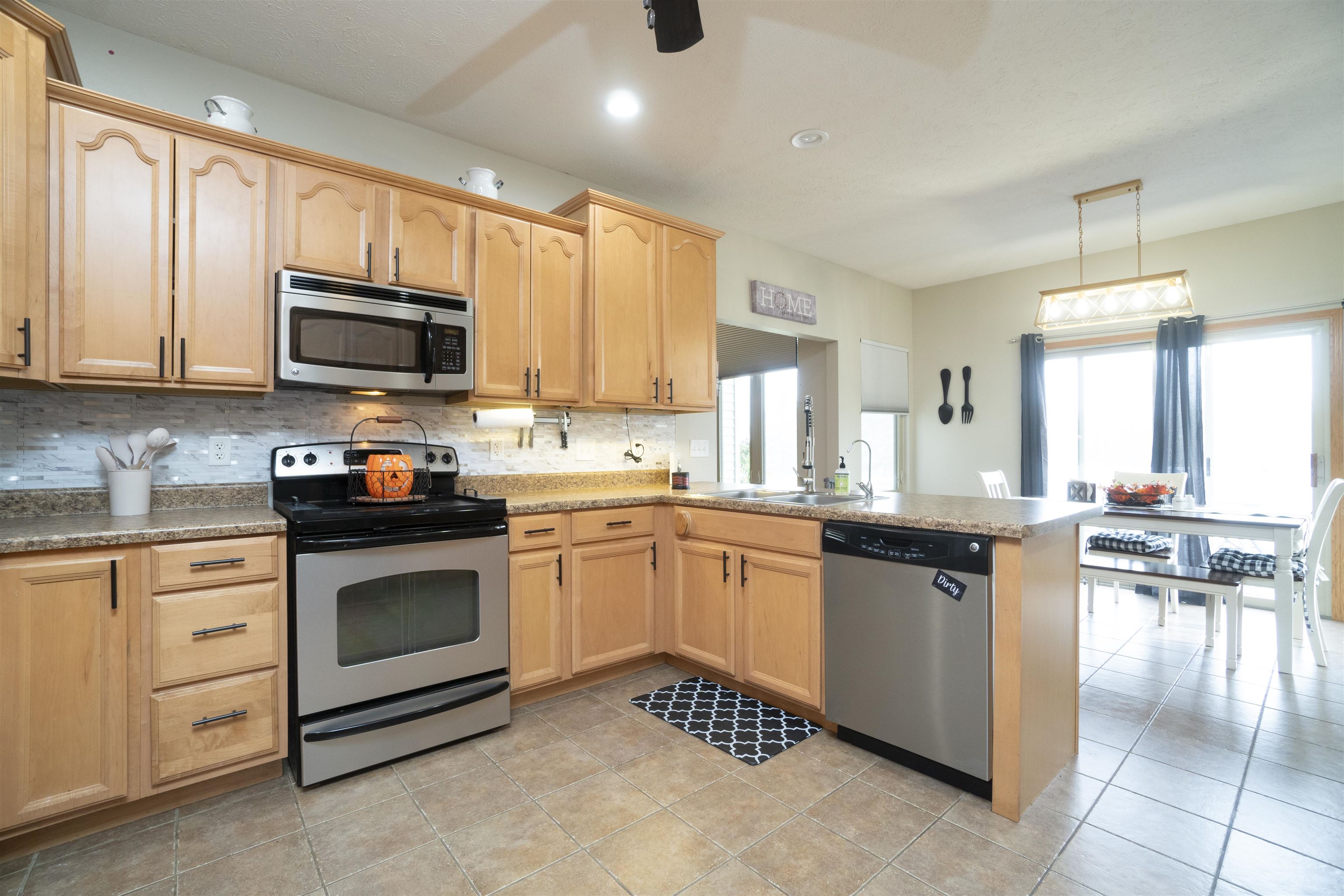 3271 North Silver Ridge Drive Oregon, IL 61061 - Photo 15 of 45 a kitchen with granite countertop a stove sink microwave and cabinets