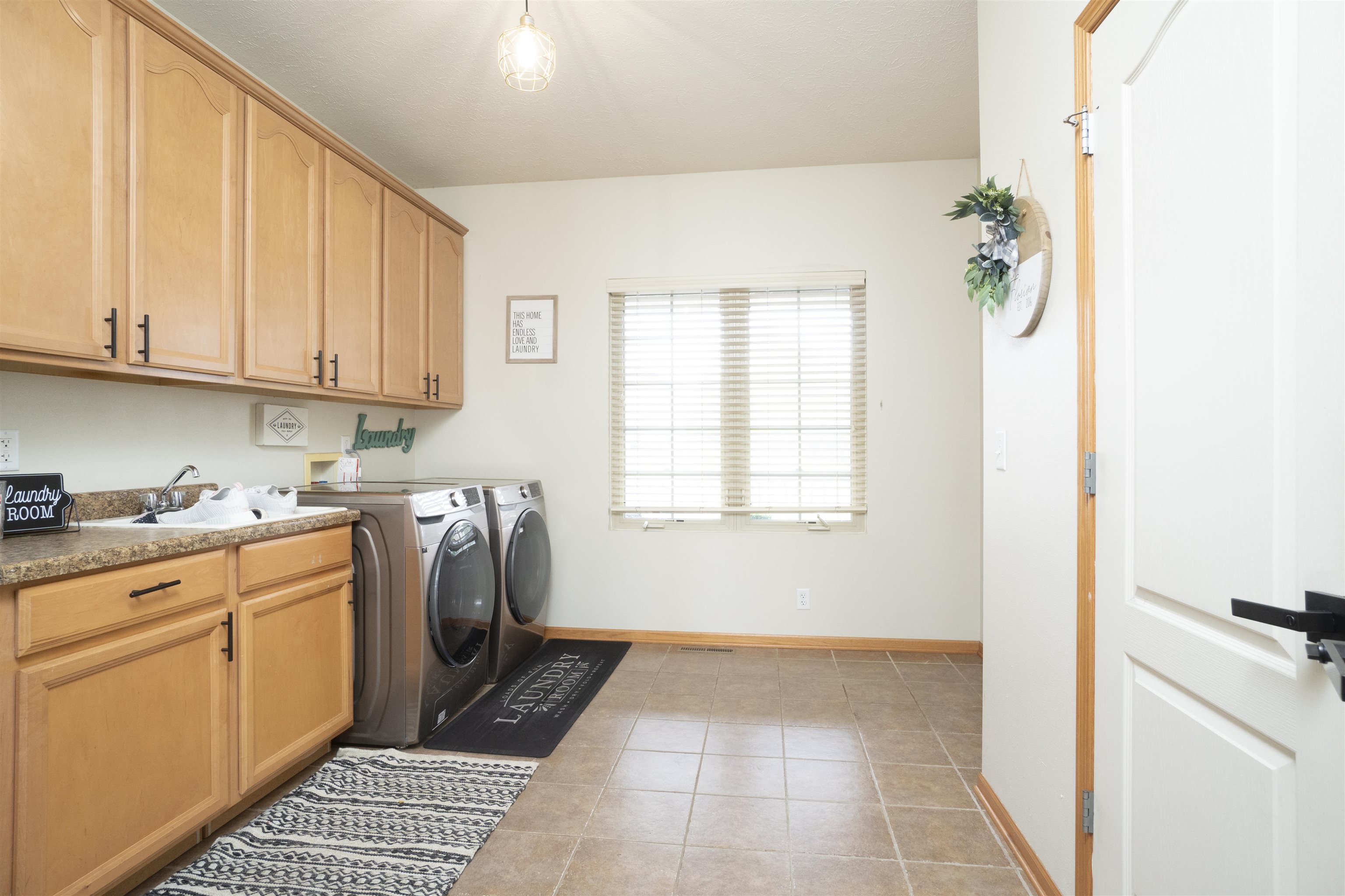 3271 North Silver Ridge Drive Oregon, IL 61061 - Photo 16 of 45 a utility room with sink a washer and dryer