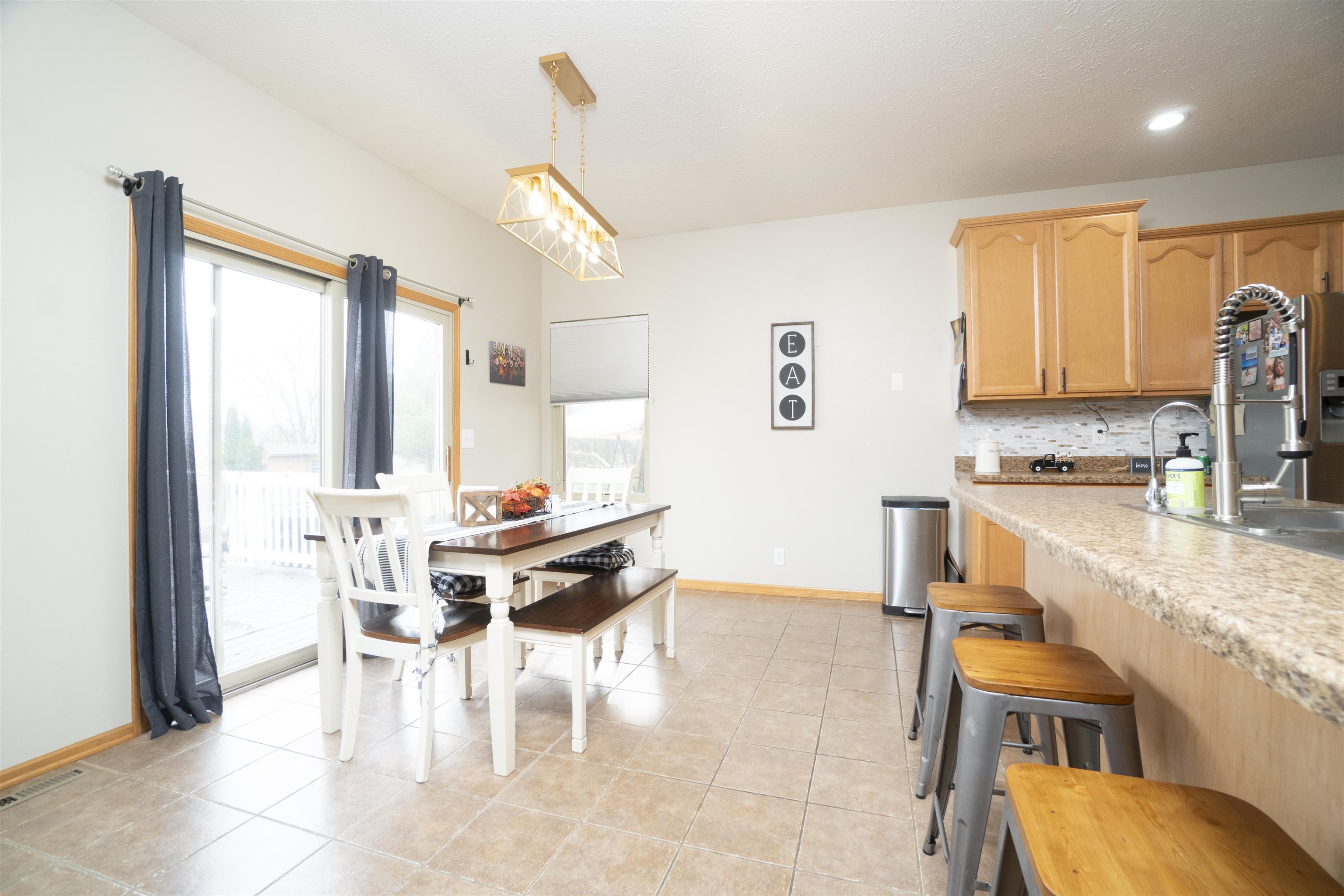 3271 North Silver Ridge Drive Oregon, IL 61061 - Photo 10 of 45 a kitchen with a dining table chairs and a view of living room
