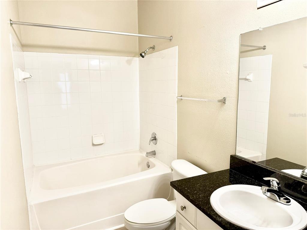 8842 Villa View Circle, Unit 3 Orlando, FL 32821 - Photo 13 of 21 a bathroom with a sink a toilet and a bathtub