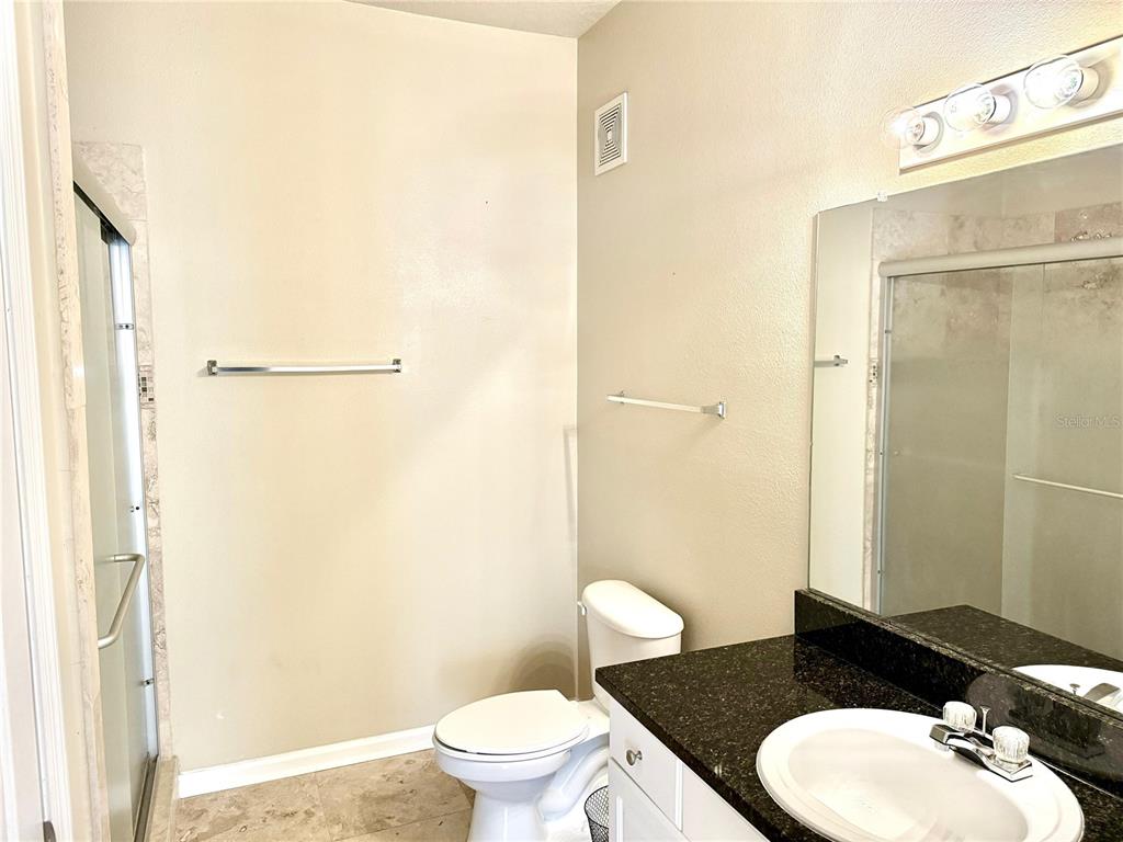 8842 Villa View Circle, Unit 3 Orlando, FL 32821 - Photo 15 of 21 a bathroom with a toilet a sink and shower
