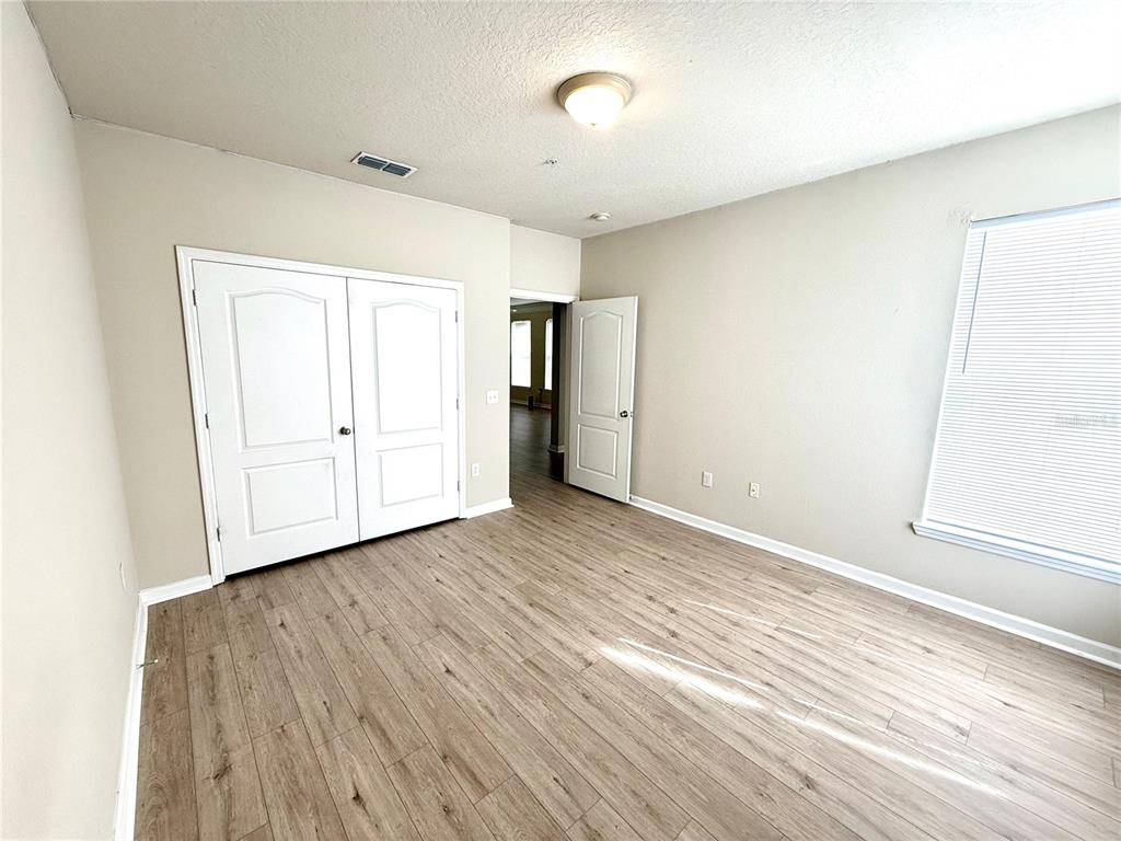 8842 Villa View Circle, Unit 3 Orlando, FL 32821 - Photo 18 of 21 an empty room with wooden floor and cabinet
