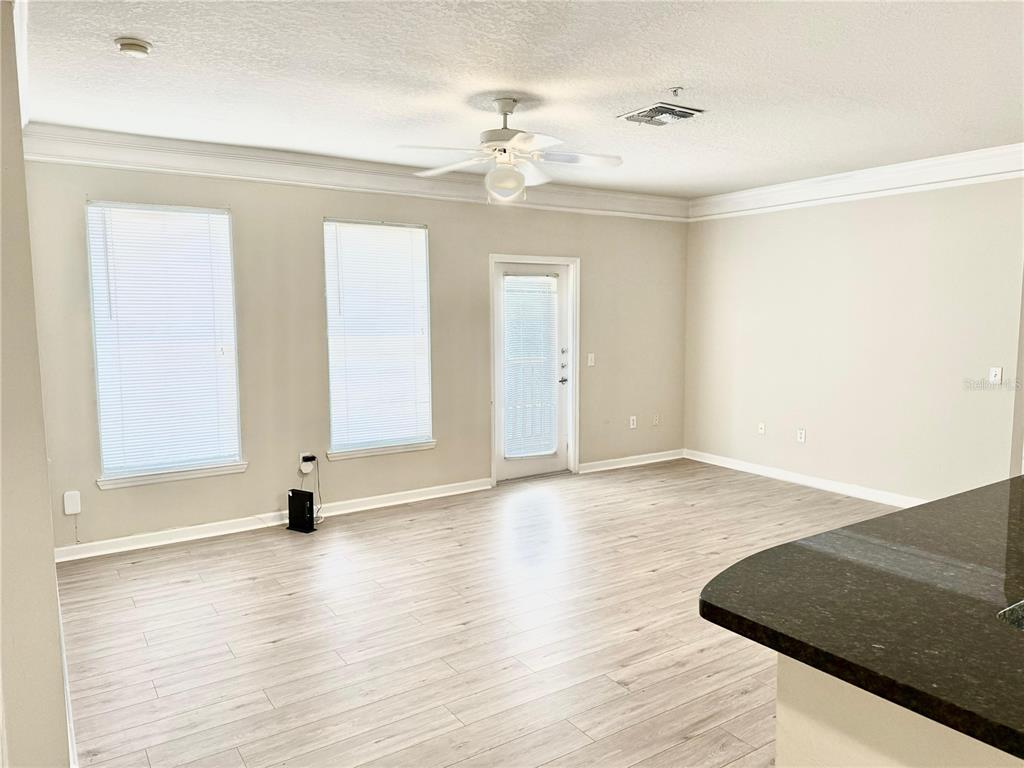 8842 Villa View Circle, Unit 3 Orlando, FL 32821 - Photo 6 of 21 wooden floor in an empty room with a window