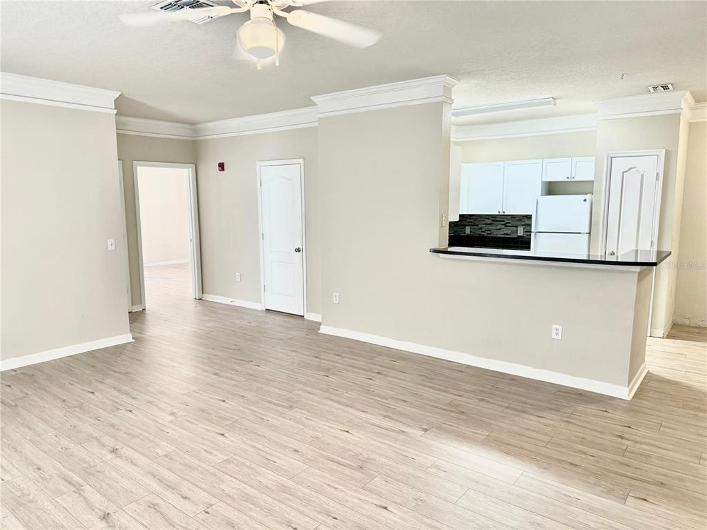 8842 Villa View Circle, Unit 3 Orlando, FL 32821 - Photo 9 of 21 a view of a kitchen with wooden floor and a ceiling fan