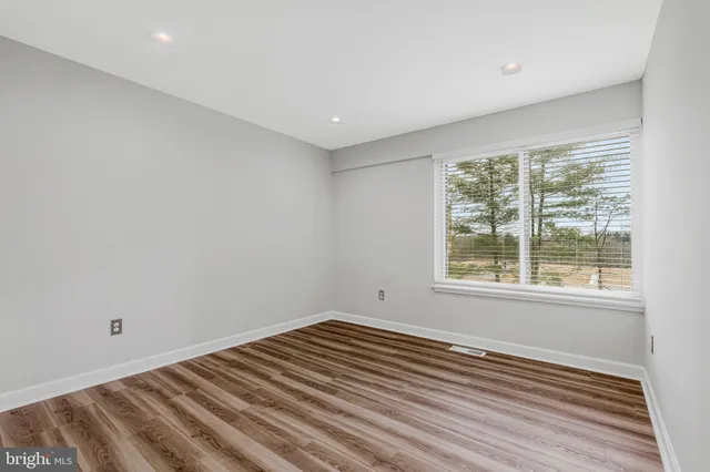 a view of room with wooden floor and fan