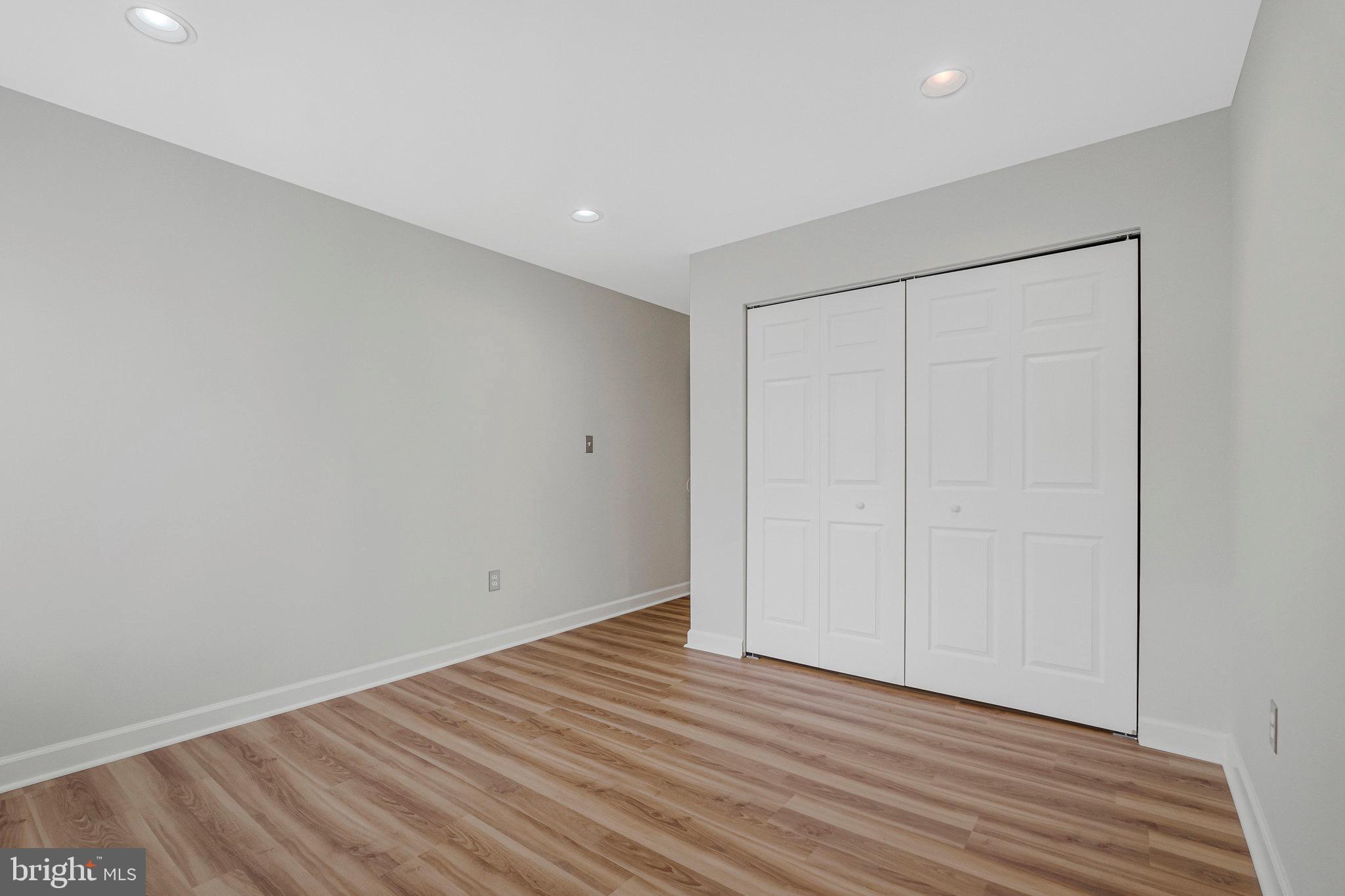1801 Ivy Oak Square, Unit 65 Reston, VA 20190 - Photo 16 of 43 a view of an empty room with wooden floor