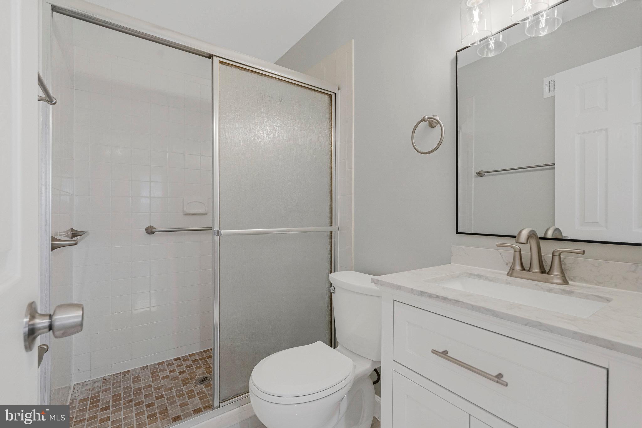 1801 Ivy Oak Square, Unit 65 Reston, VA 20190 - Photo 19 of 43 a bathroom with a sink a toilet and shower