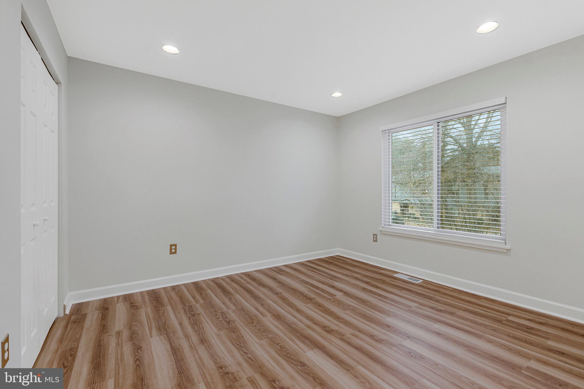 1801 Ivy Oak Square, Unit 65 Reston, VA 20190 - Photo 22 of 43 wooden floor in an empty room with a window