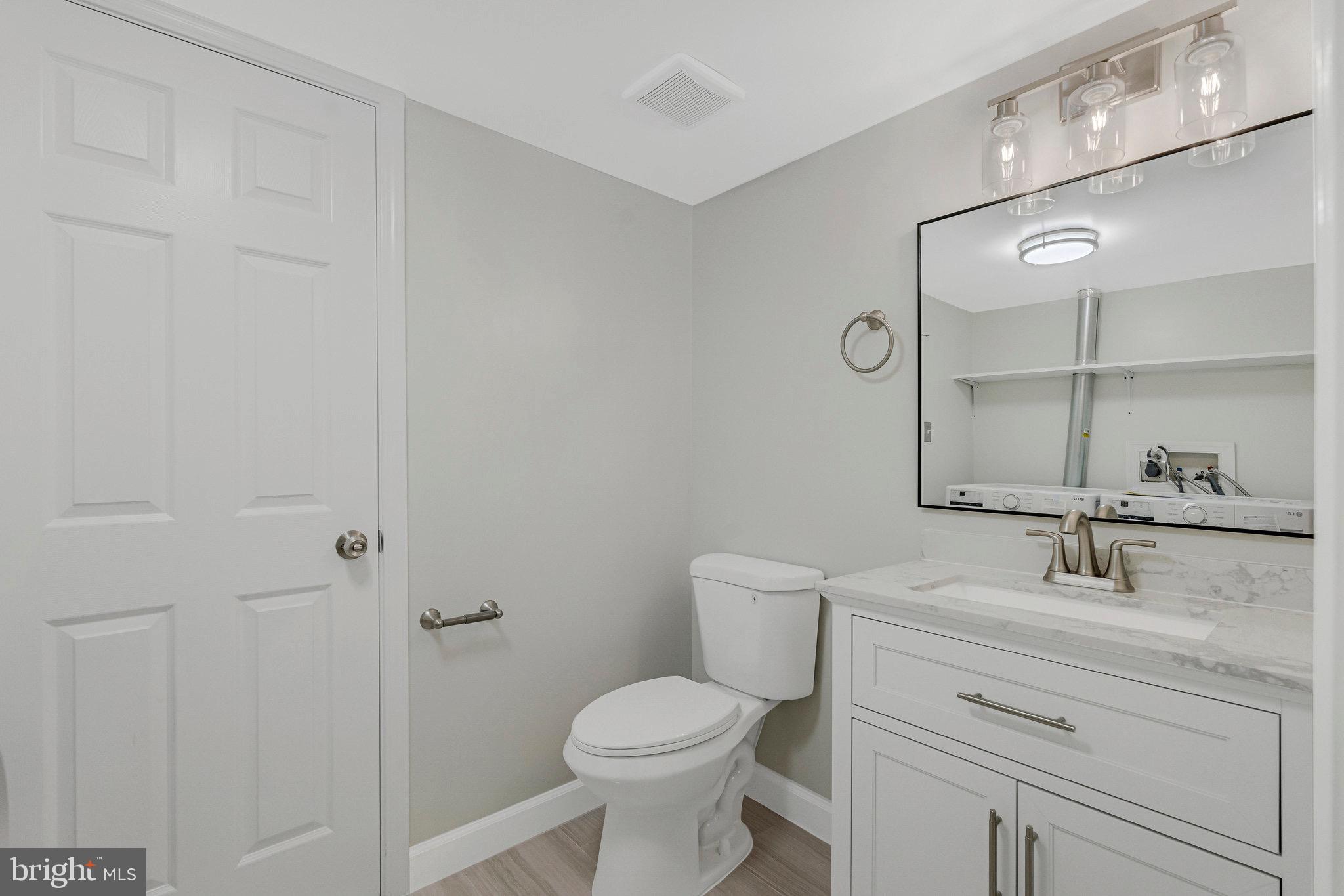 1801 Ivy Oak Square, Unit 65 Reston, VA 20190 - Photo 25 of 43 a bathroom with a sink toilet and vanity