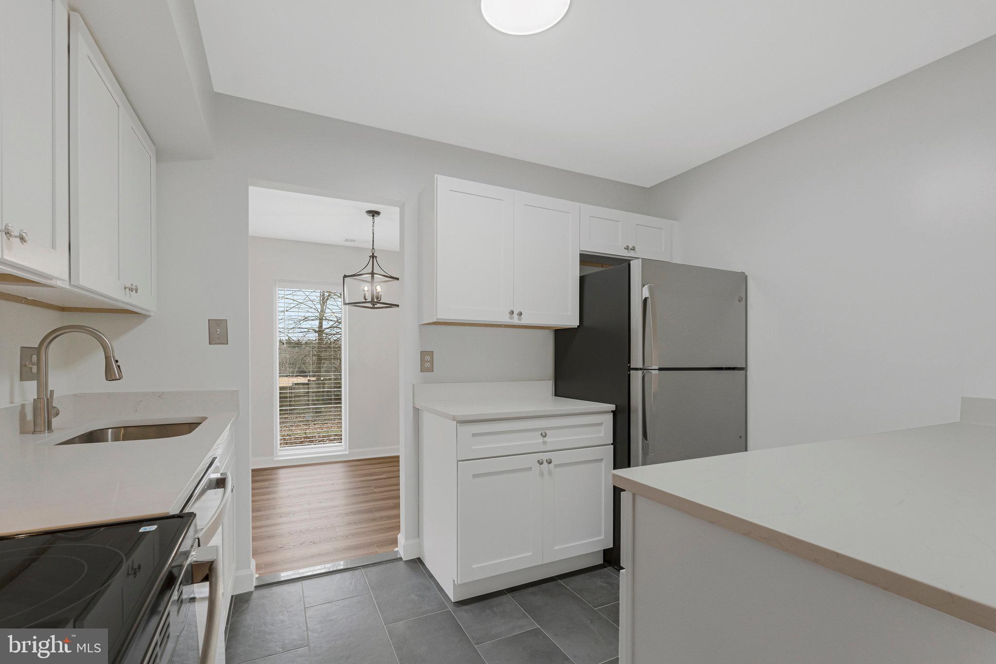 1801 Ivy Oak Square, Unit 65 Reston, VA 20190 - Photo 33 of 43 a kitchen with a sink a stove and refrigerator