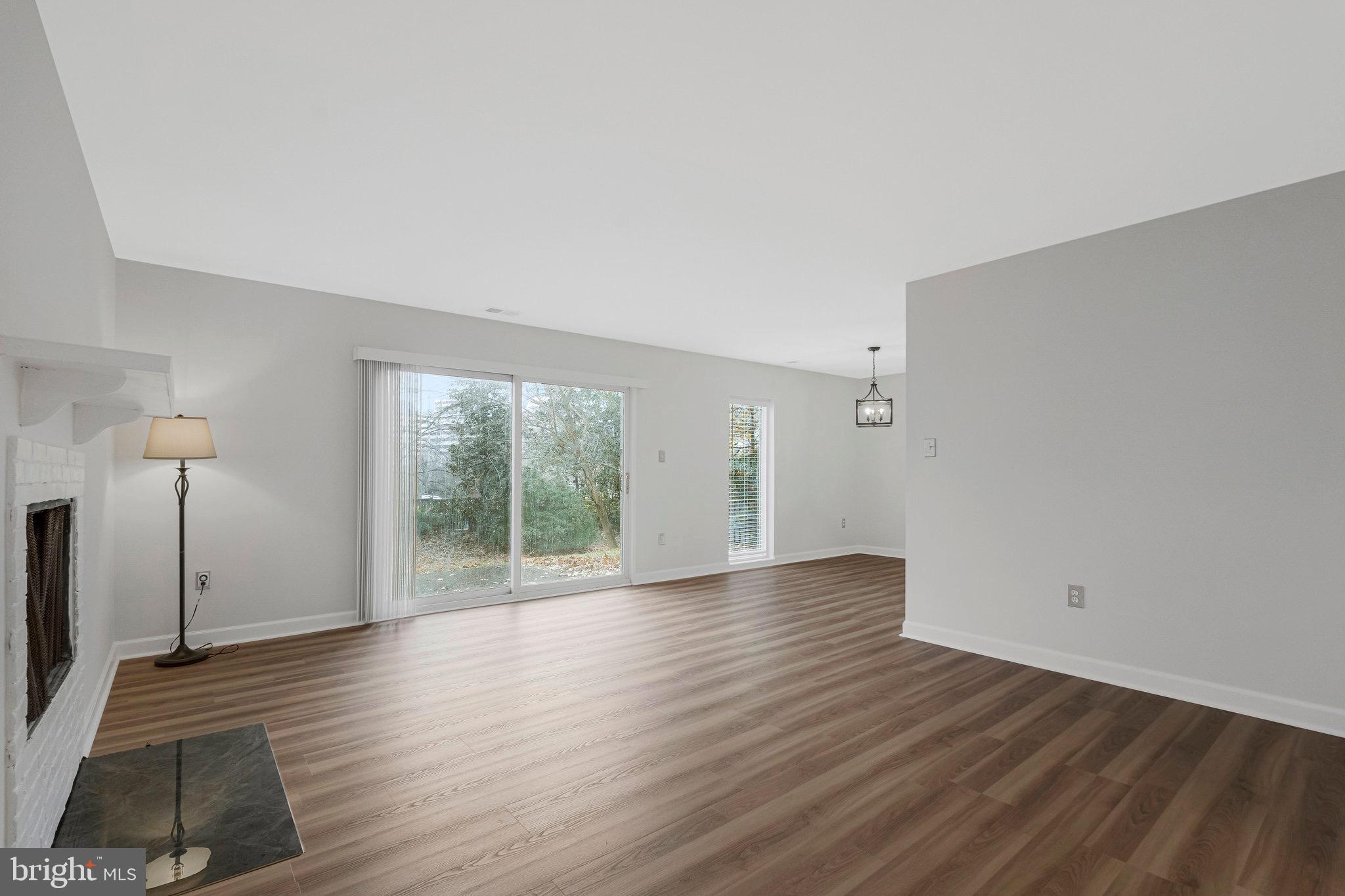 1801 Ivy Oak Square, Unit 65 Reston, VA 20190 - Photo 8 of 43 a view of a room with wooden floor and a window