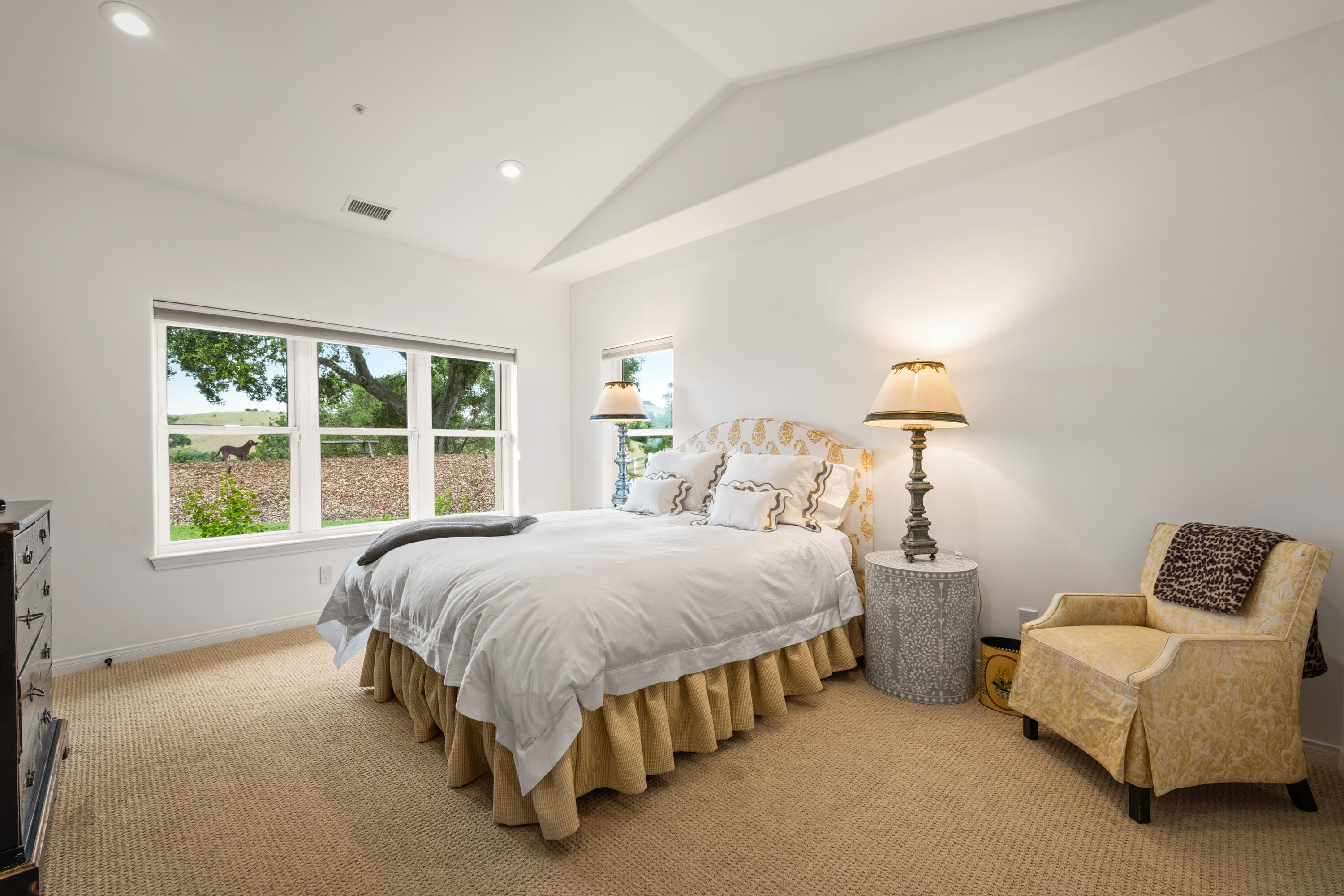 2502 Pepper Tree Ranch Road Santa Ynez, CA 93460 - Photo 15 of 32 a spacious bedroom with a bed and a couch