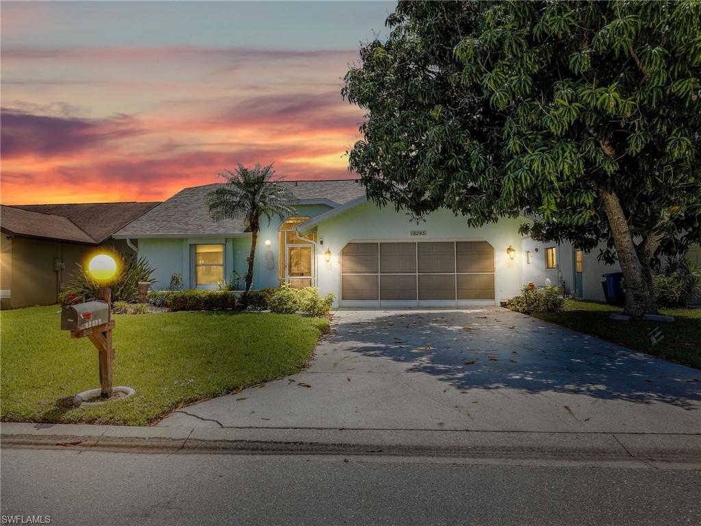 13243 Heather Ridge Loop Fort Myers, FL 33966 - Photo 1 of 34 a front view of a house with a yard and garage