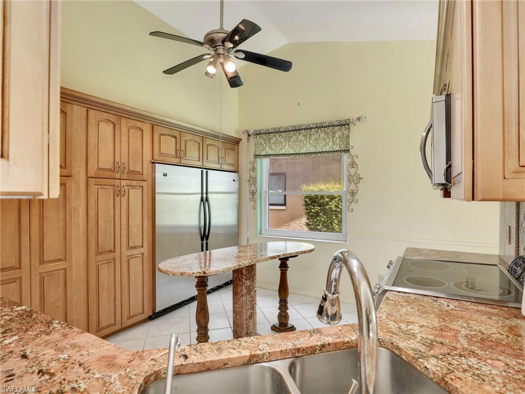 13243 Heather Ridge Loop Fort Myers, FL 33966 - Photo 16 of 34 a view of a kitchen with a sink a mirror and a fan
