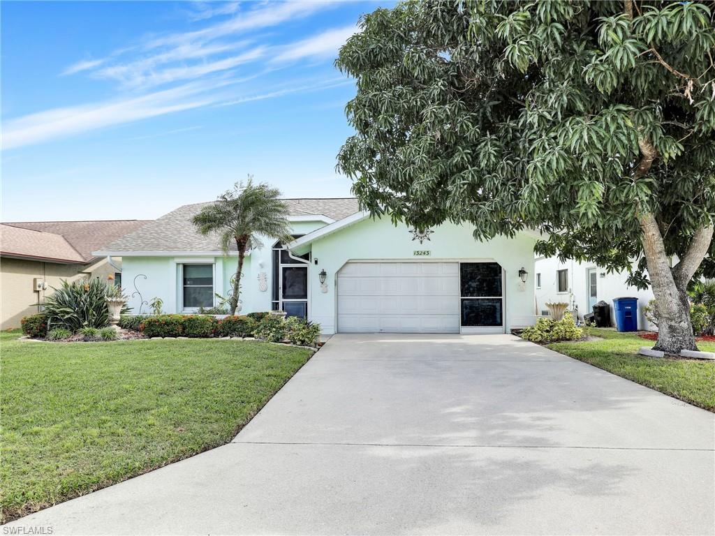 13243 Heather Ridge Loop Fort Myers, FL 33966 - Photo 2 of 34 a front view of a house with a yard and a garage