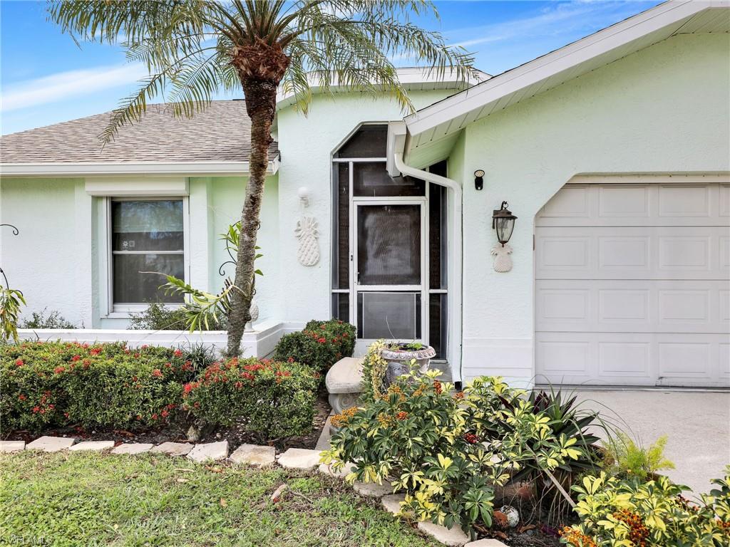13243 Heather Ridge Loop Fort Myers, FL 33966 - Photo 3 of 34 a front view of a house having yard