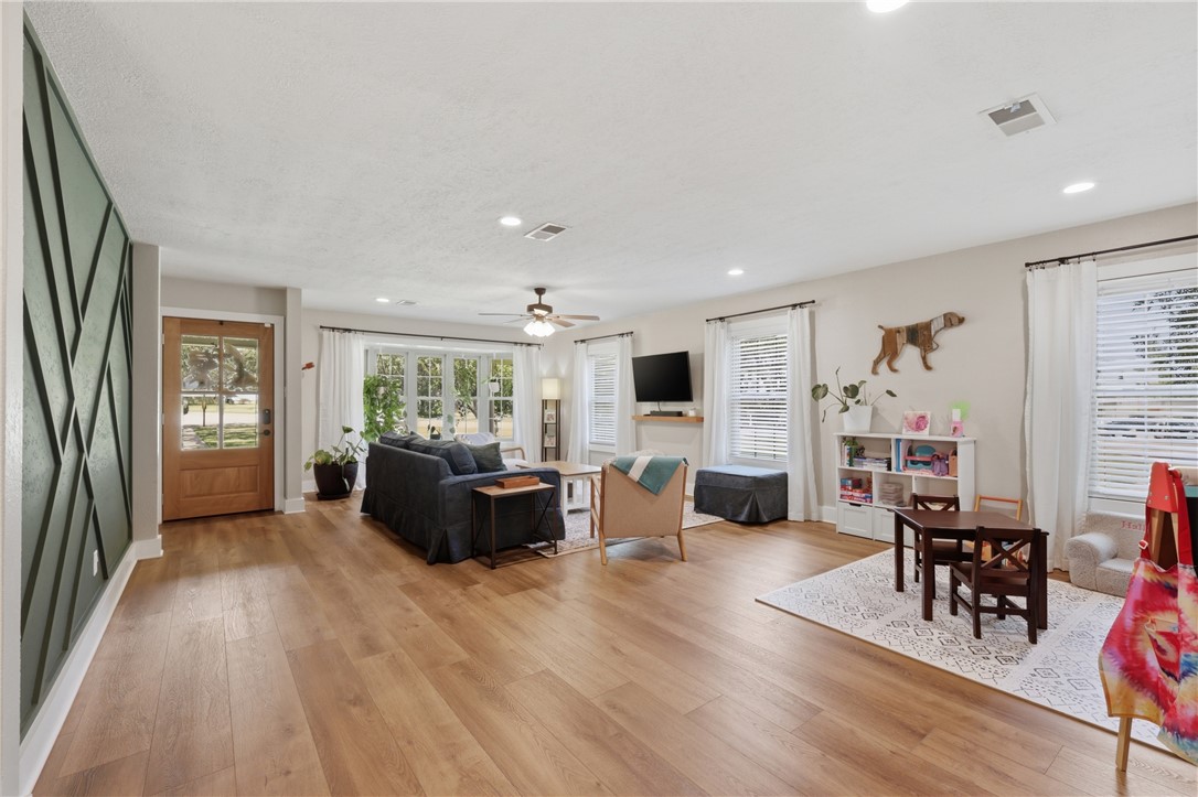 515 Crescent Drive Bryan, TX 77801 - Photo 5 of 43 Spacious living area featuring wood-looking LVP flooring, recessed lighting, and multiple windows