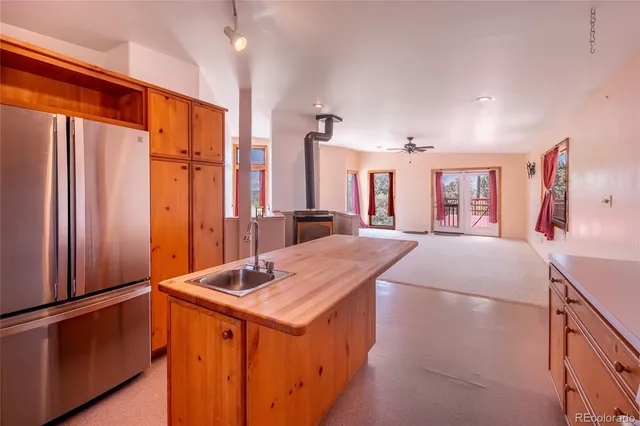 a kitchen with stainless steel appliances a sink and a refrigerator
