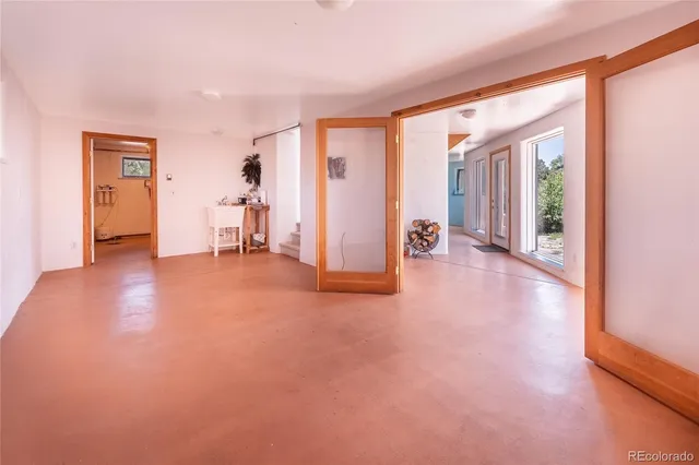 an empty room with windows and closet