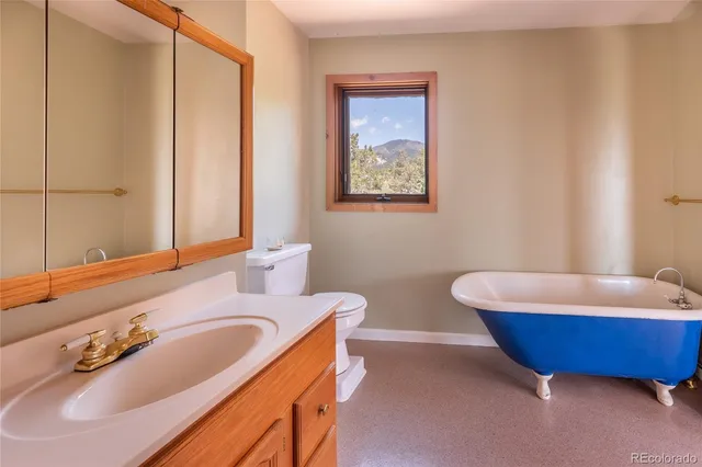a bathroom with a tub sink and mirror