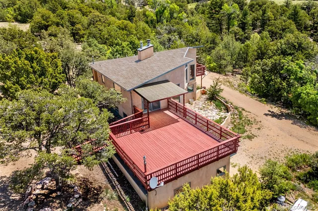 a view of a balcony with wooden floor and fence