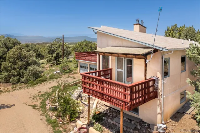 a view of a roof deck with wooden fence