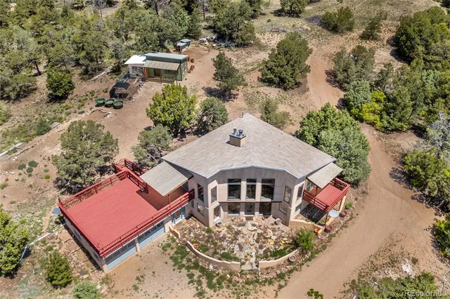 an aerial view of a house with a yard