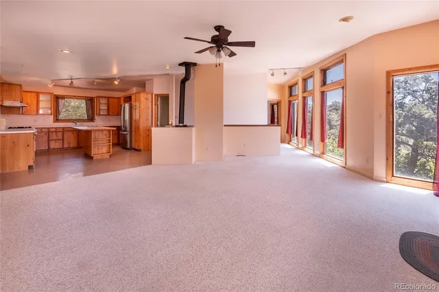 a view of a livingroom with furniture and a ceiling fan