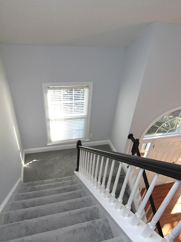 9021 Breeland Way Raleigh, NC 27613 - Photo 15 of 20 Looking down the stairway shows the beautiful window that lights the way during the daylight hours! Stairway!