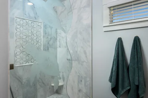 a bathroom with a shower and toilet