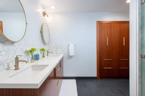 a bathroom with a sink vanity and a mirror