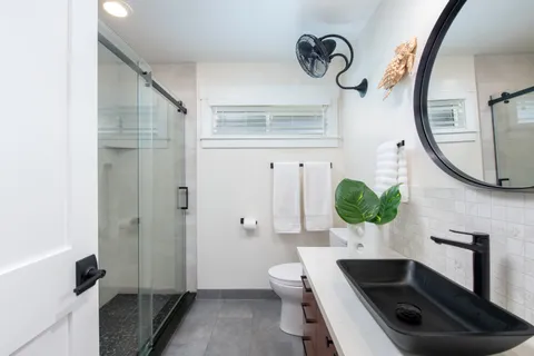 a bathroom with a sink a toilet and a mirror