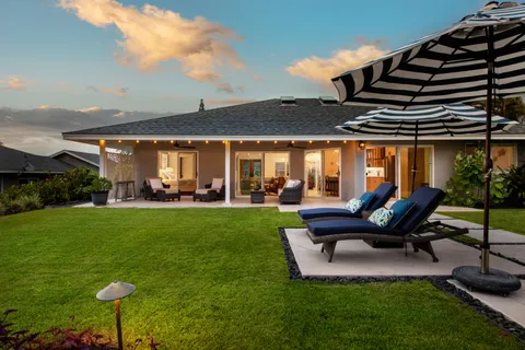 a view of a patio with table and chairs potted plants and a large tree