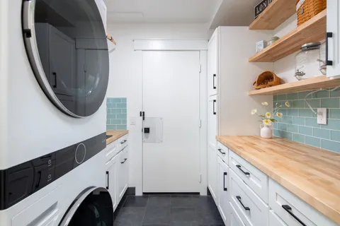 a bathroom with a sink a washer and dryer