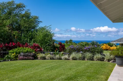 a view of a garden with a building in the background