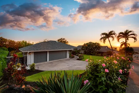 a view of a house with a yard and garden