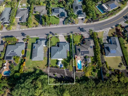 an aerial view of multiple houses with yard