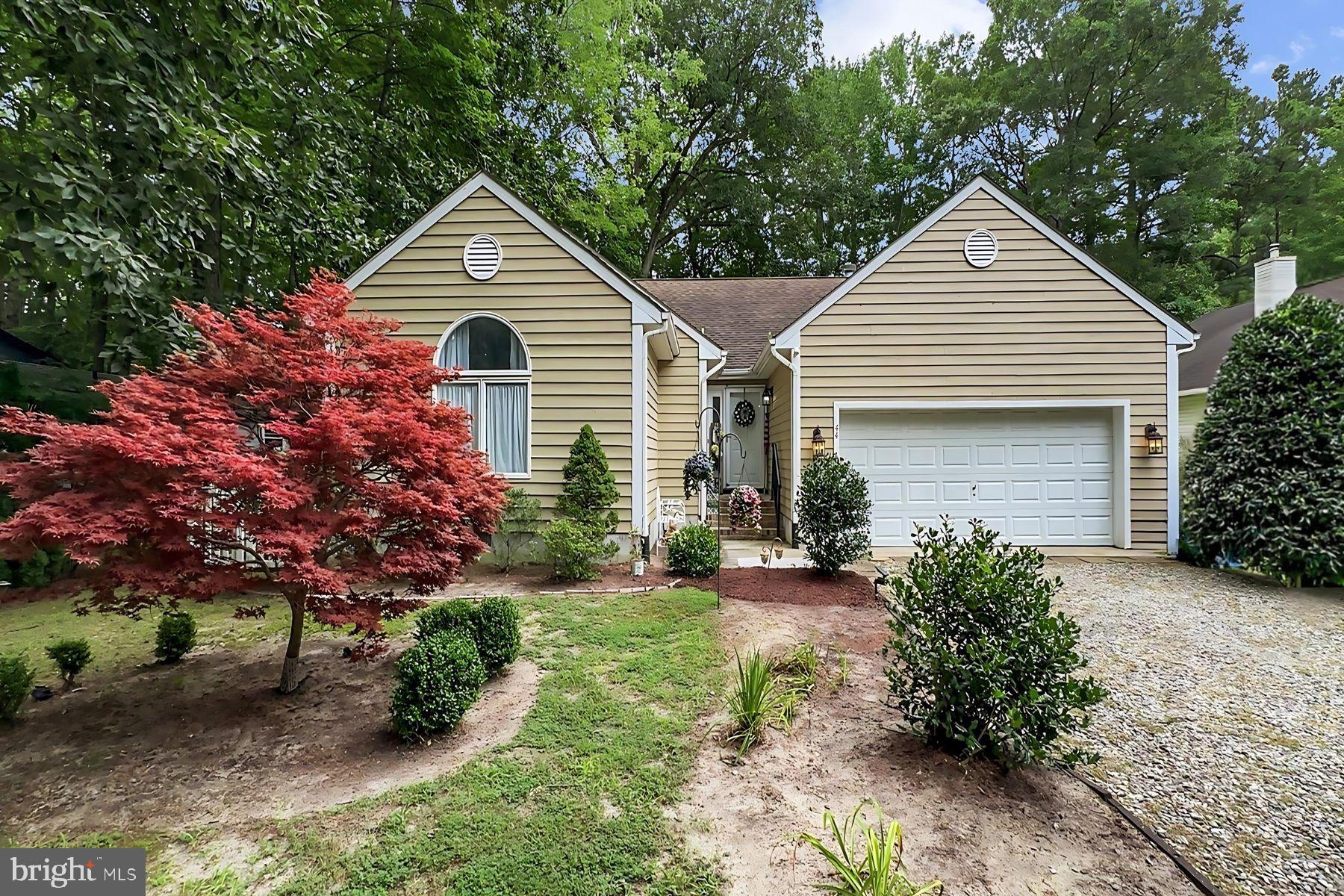 44 Beaconhill Road Ocean Pines, MD 21811 - Photo 1 of 28 a front view of a house with a yard and garage